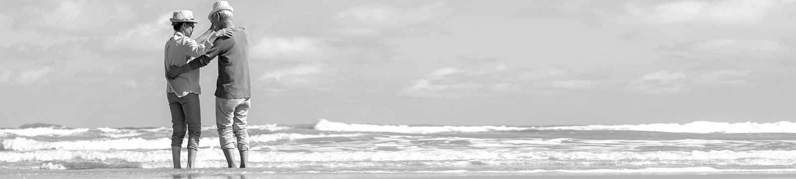 older couple dancing on beach