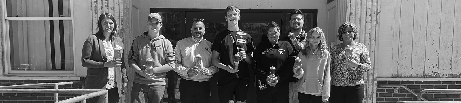 students accepting donated water bottles