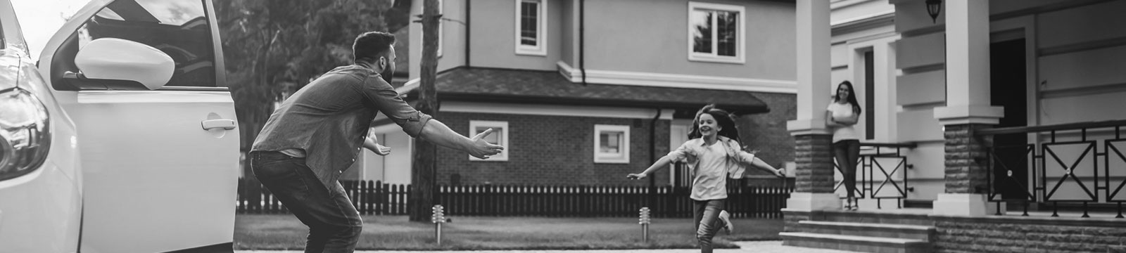 dad greeting young daughter outside home